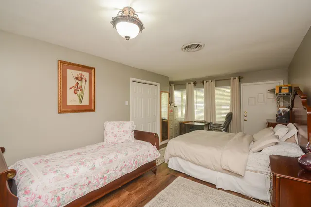 a bedroom with a large bed and a chandelier