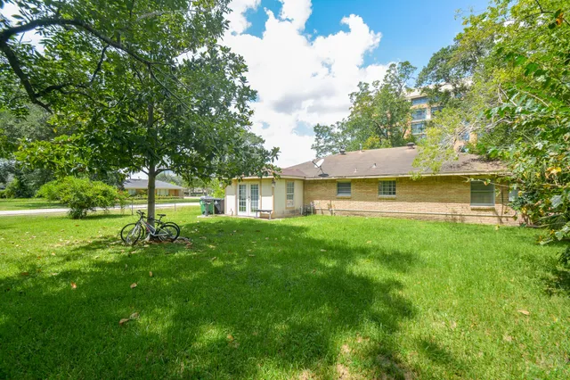 a view of a house with a yard and sitting area