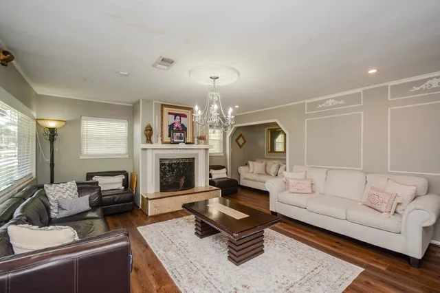 a living room with furniture fireplace and window