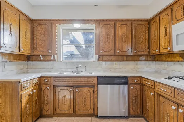 a kitchen with a sink cabinets and wooden floor