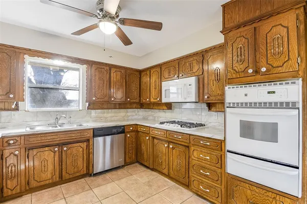 a kitchen with stainless steel appliances granite countertop a stove sink and cabinets