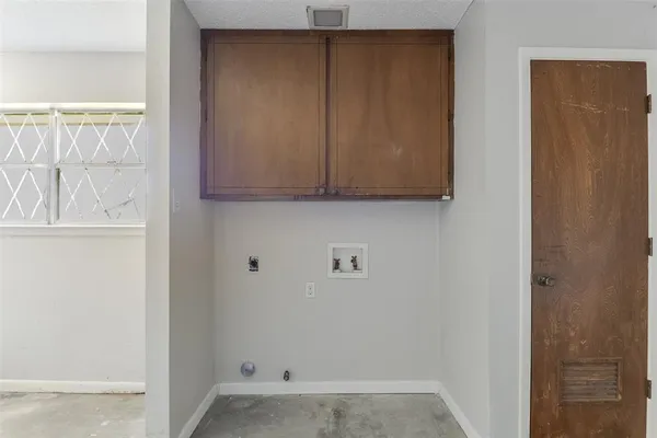 a view of a room with wooden floor and cabinet