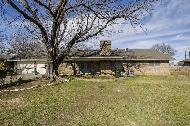 a view of a house with a yard and sitting area