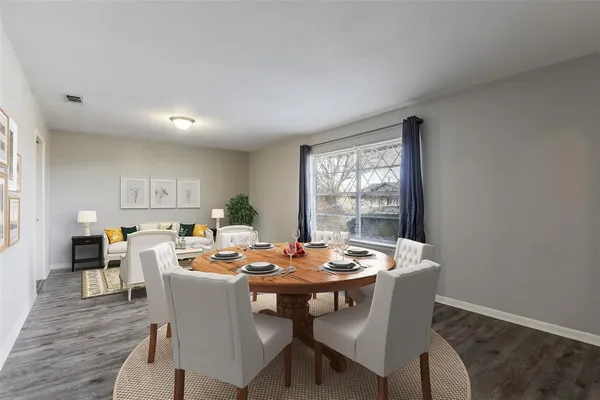 a dining room with furniture window and wooden floor