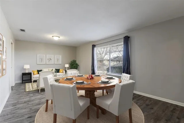 a dining room with furniture window and wooden floor