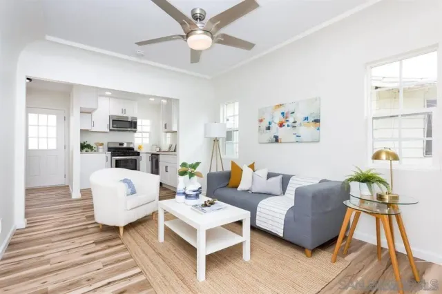a living room with furniture fireplace and wooden floor