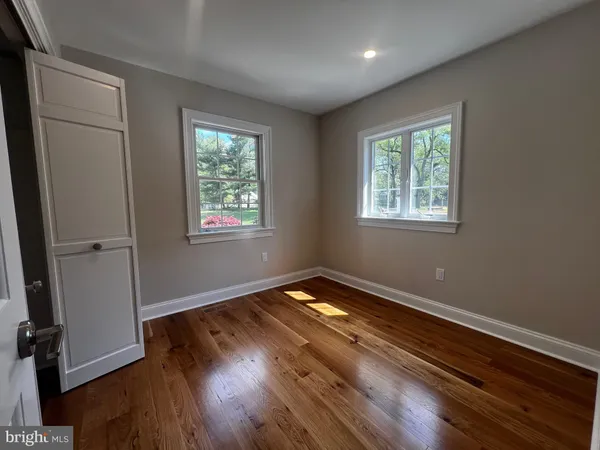 a living room with a rug and a window