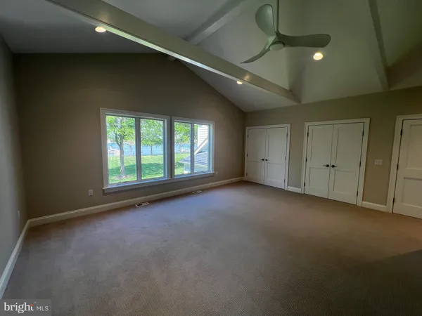 a bathroom with double vanity and a mirror