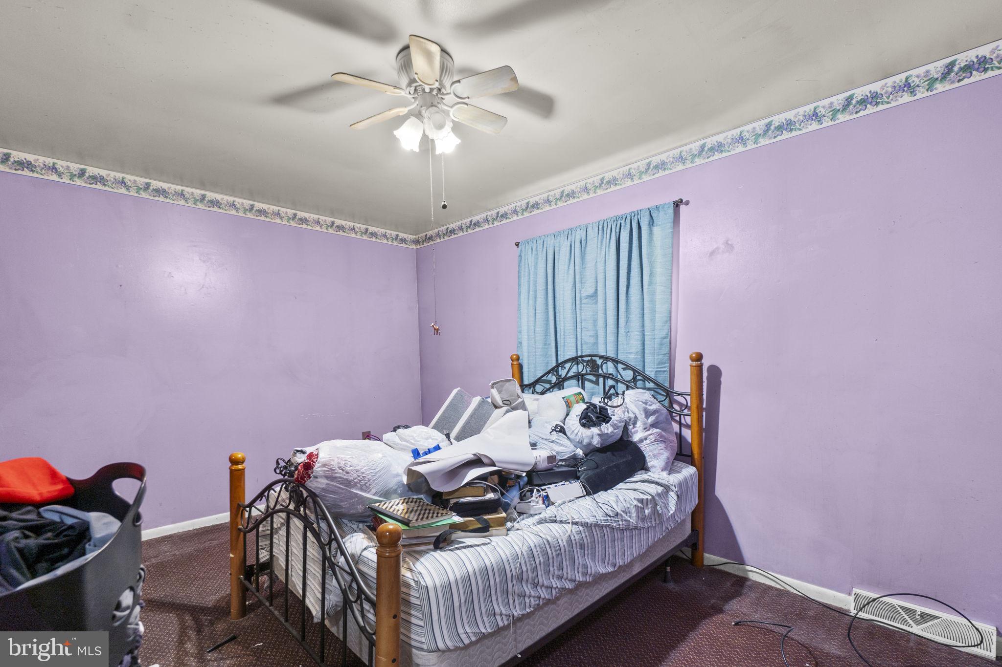 6403 Ford Road Frederick, MD 21702 - Photo 11 of 19 a bed room with a bed and a chandelier