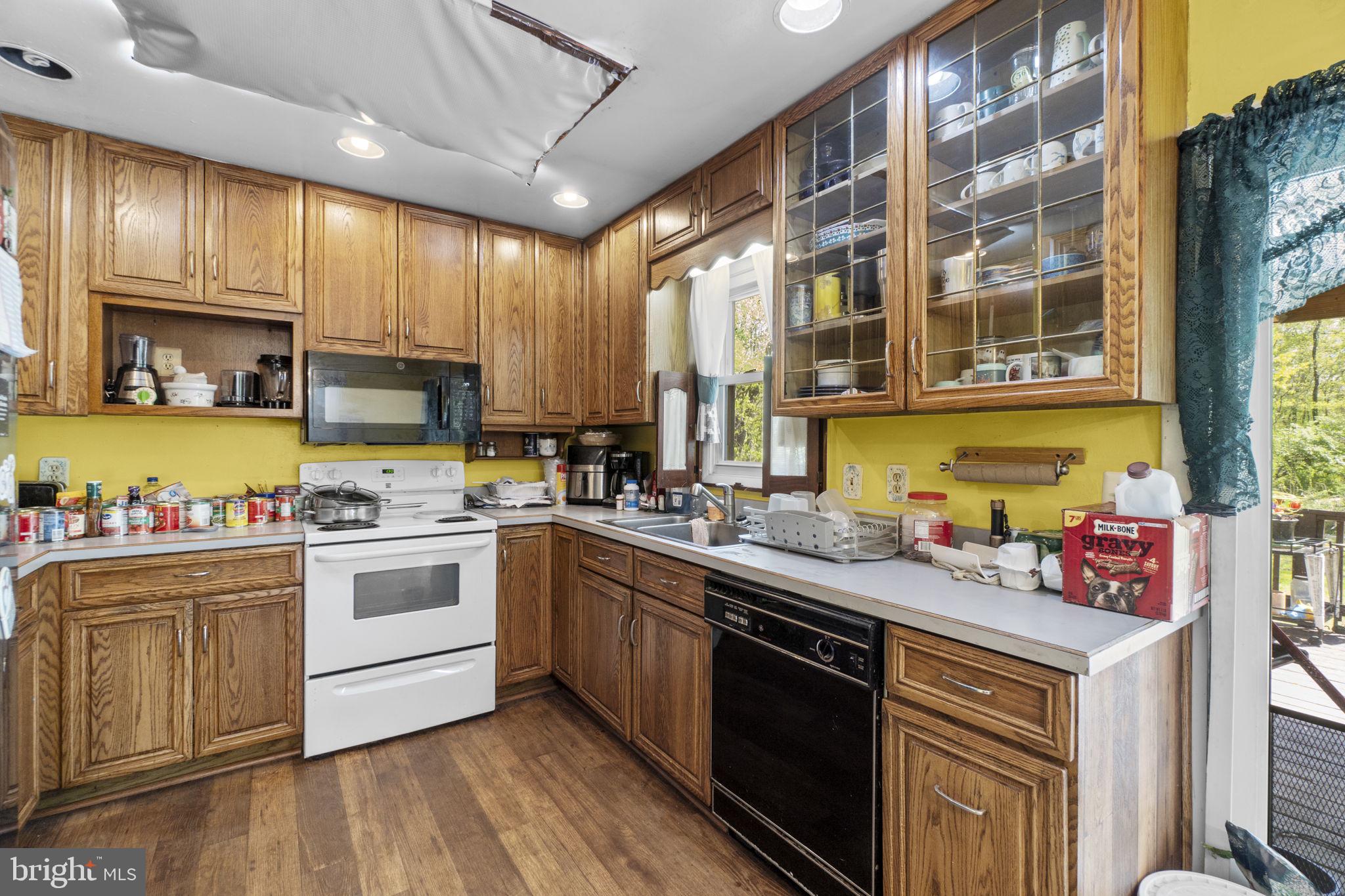 6403 Ford Road Frederick, MD 21702 - Photo 4 of 19 a kitchen with stainless steel appliances granite countertop wooden cabinets a sink dishwasher a stove and a refrigerator with wooden floor