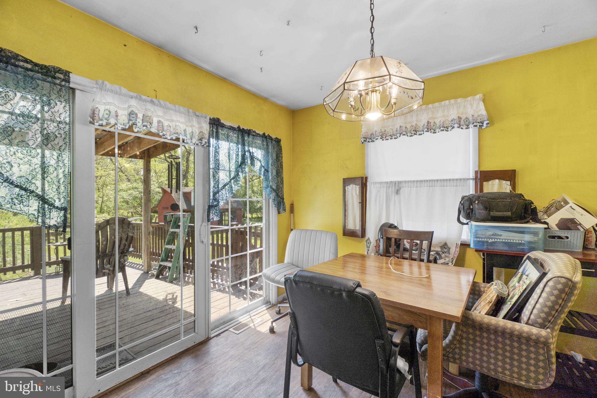 6403 Ford Road Frederick, MD 21702 - Photo 6 of 19 a dining room with furniture a chandelier and wooden floor