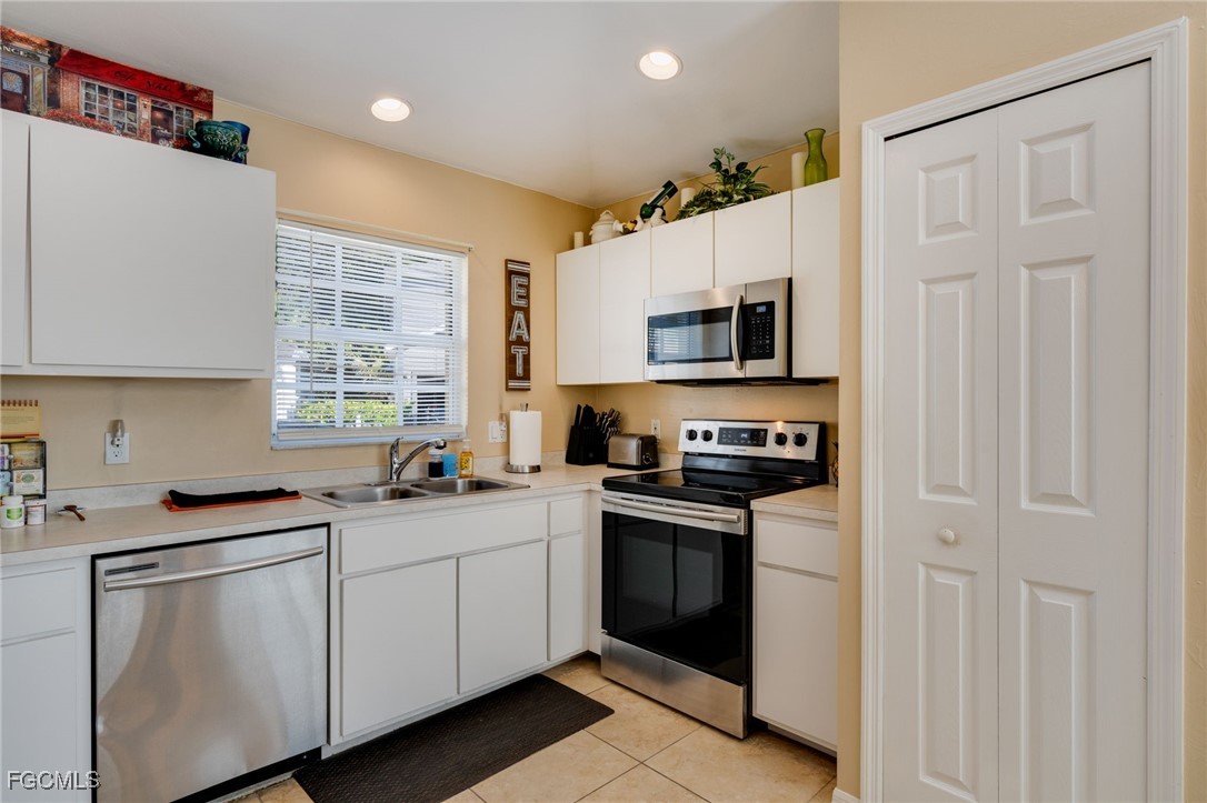 10741 Rio Mar Circle Estero, FL 33928 - Photo 12 of 23 a kitchen with a sink stove and microwave