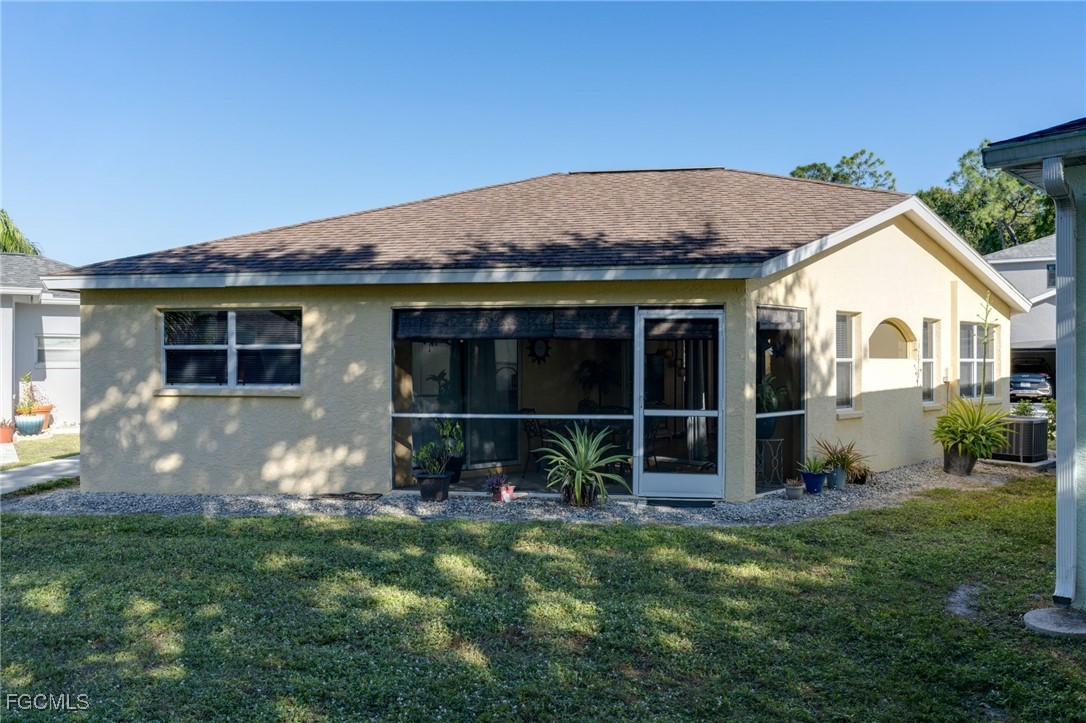 10741 Rio Mar Circle Estero, FL 33928 - Photo 16 of 23 a backyard of a house with table and chairs
