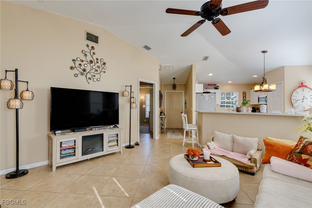10741 Rio Mar Circle Estero, FL 33928 - Photo 3 of 23 a living room with furniture and a flat screen tv