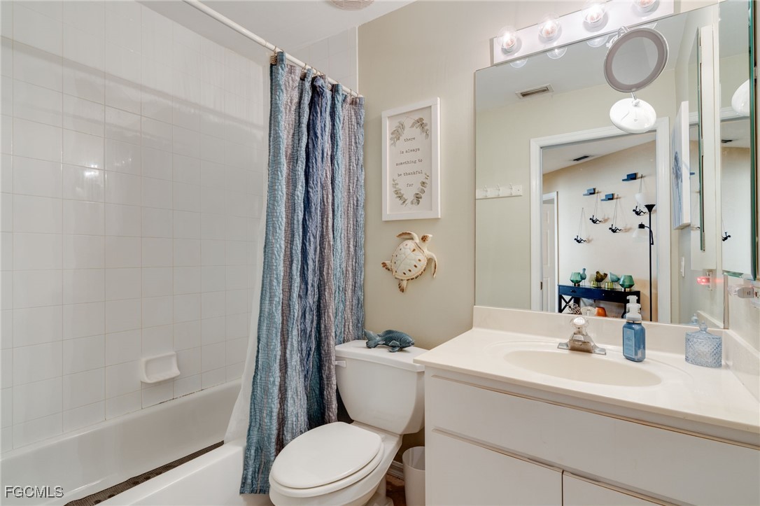 10741 Rio Mar Circle Estero, FL 33928 - Photo 5 of 23 a bathroom with a sink a toilet and shower