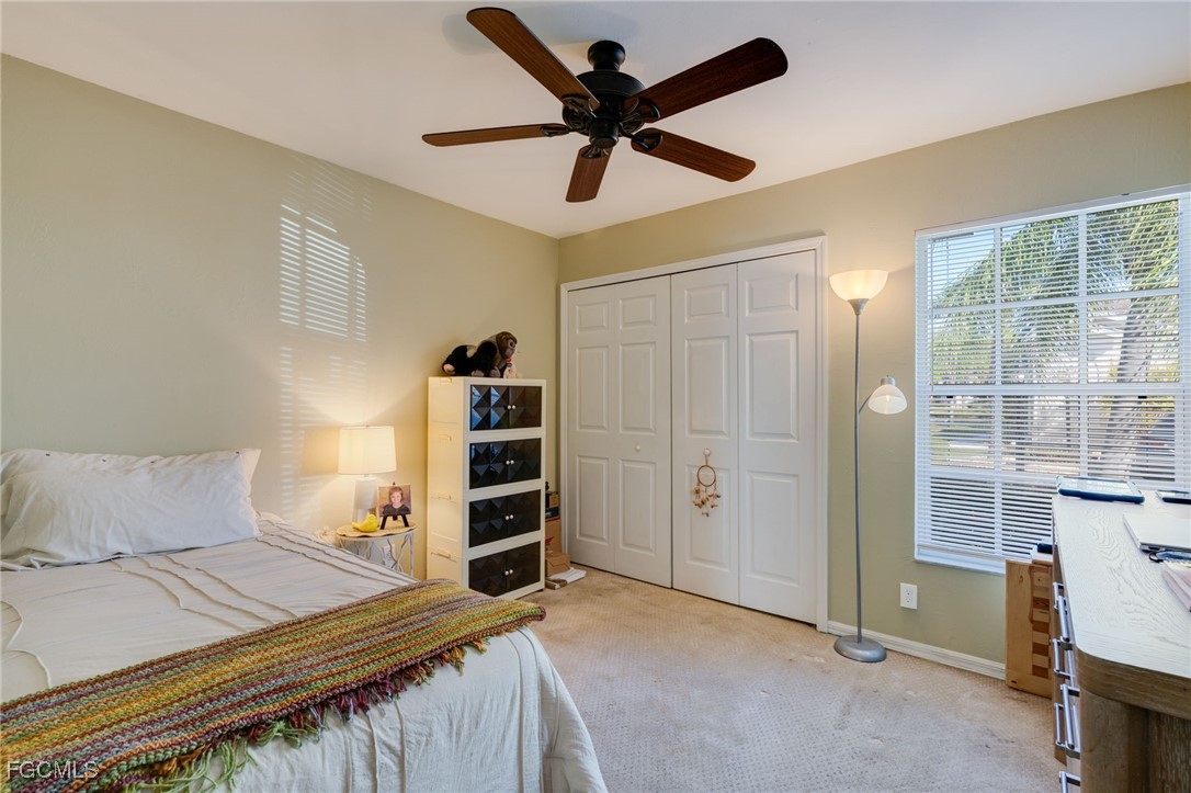 10741 Rio Mar Circle Estero, FL 33928 - Photo 6 of 23 a bedroom with a bed and a book shelf