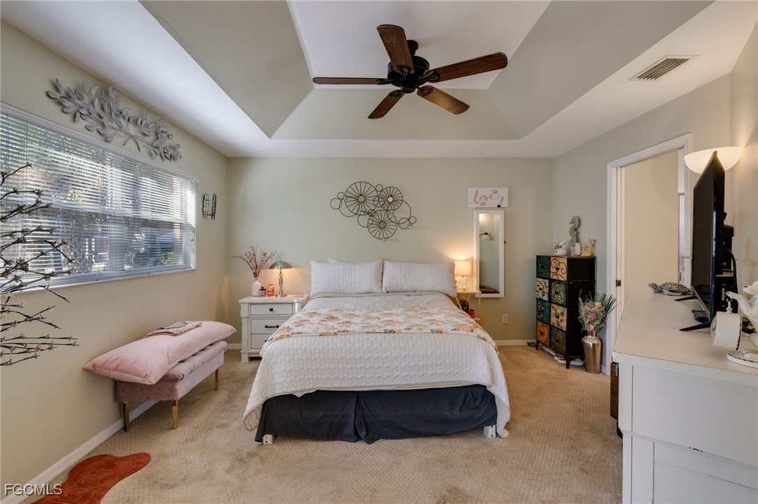 10741 Rio Mar Circle Estero, FL 33928 - Photo 8 of 23 a bedroom with a bed and a flat tv screen on the dresser