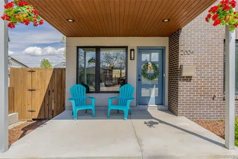 a building outdoor space with patio furniture and potted plants