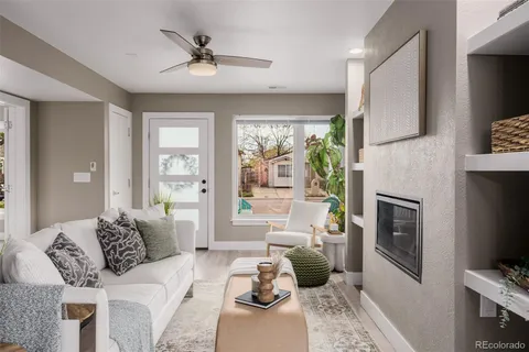a living room with furniture a fireplace and a flat screen tv
