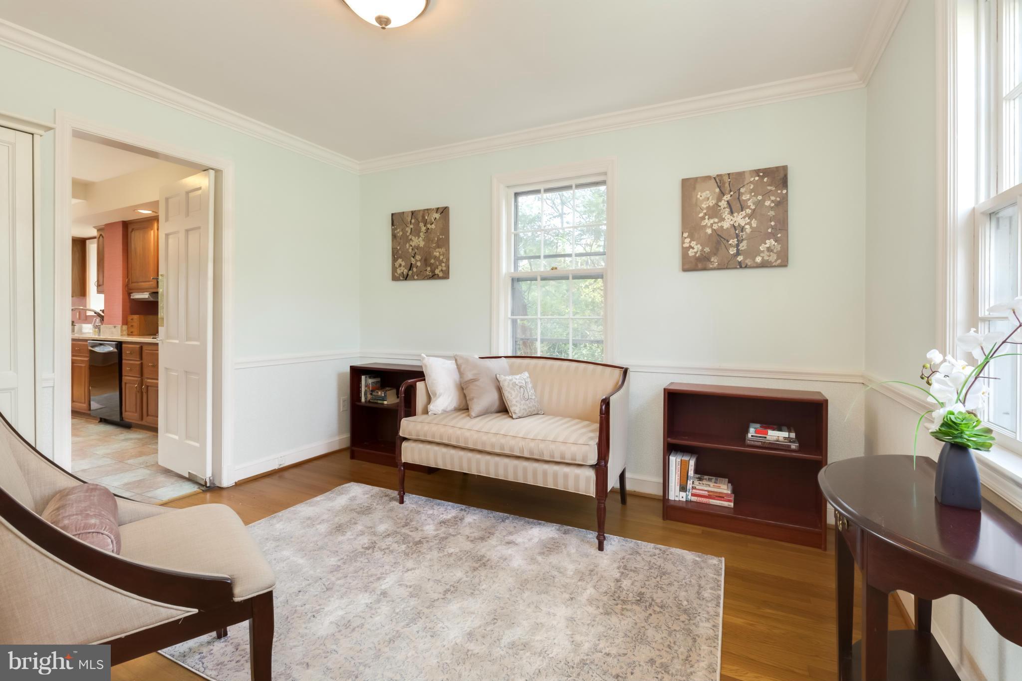 4508 19th Road North Arlington, VA 22207 - Photo 11 of 30 a living room with furniture a dining table and a fireplace