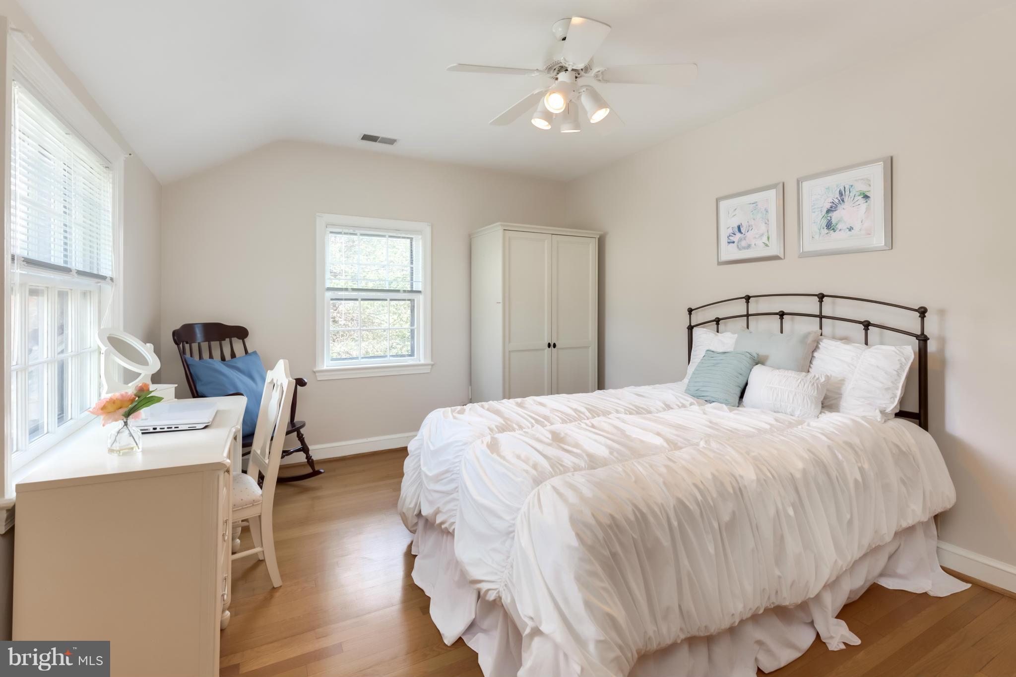 4508 19th Road North Arlington, VA 22207 - Photo 14 of 30 a bedroom with a bed a chandelier and dresser