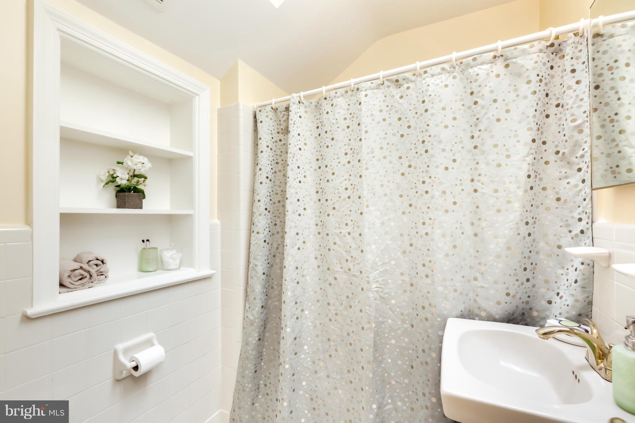 4508 19th Road North Arlington, VA 22207 - Photo 16 of 30 a bathroom with a shower curtain and a sink