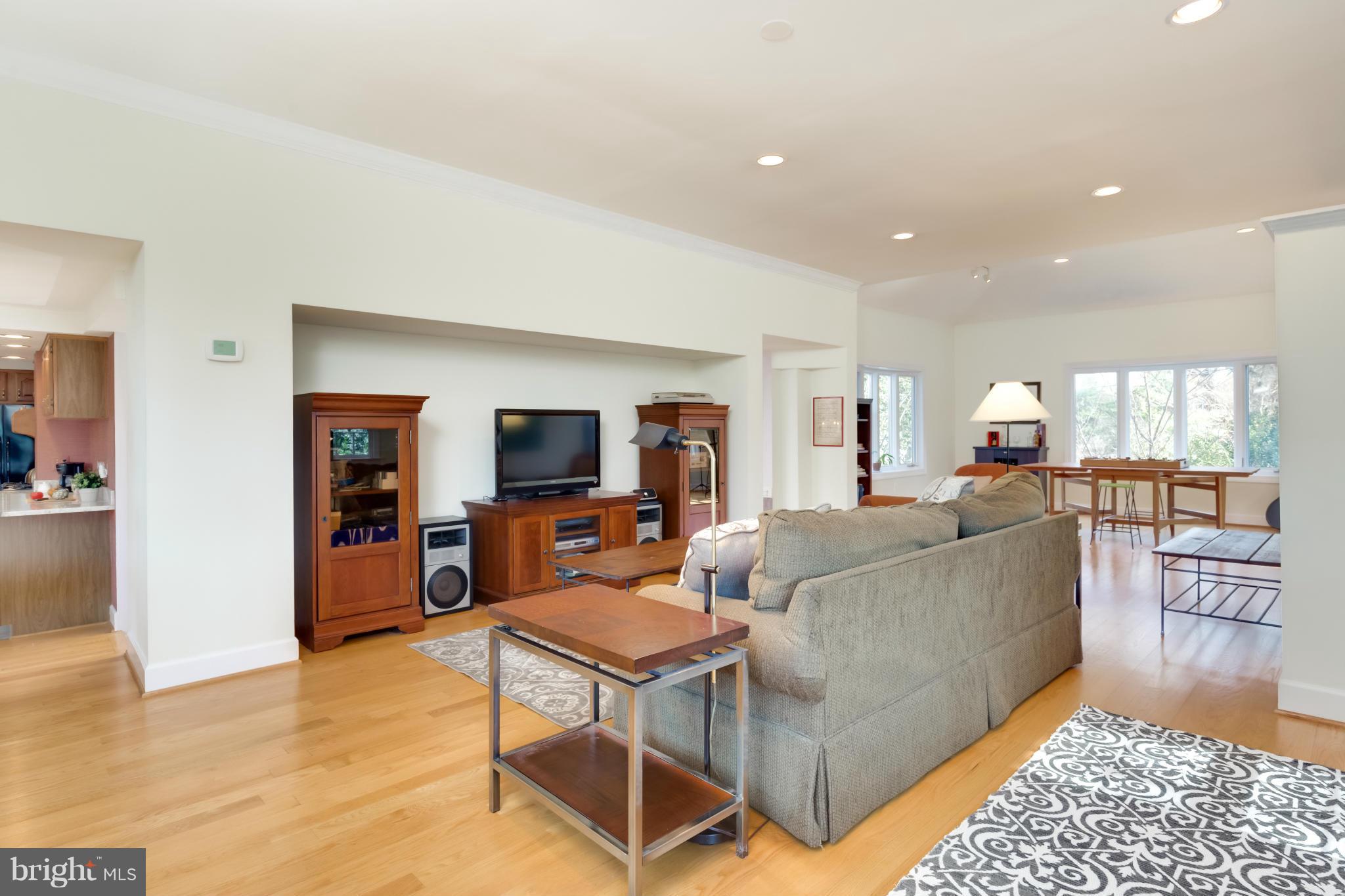 4508 19th Road North Arlington, VA 22207 - Photo 5 of 30 a living room with furniture a flat screen tv and kitchen view
