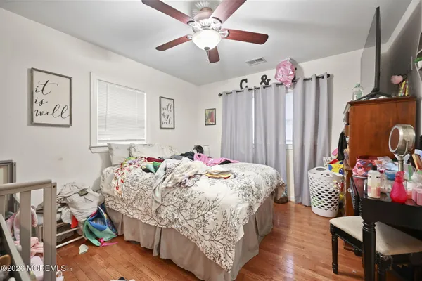 a bedroom with bed and a chandelier