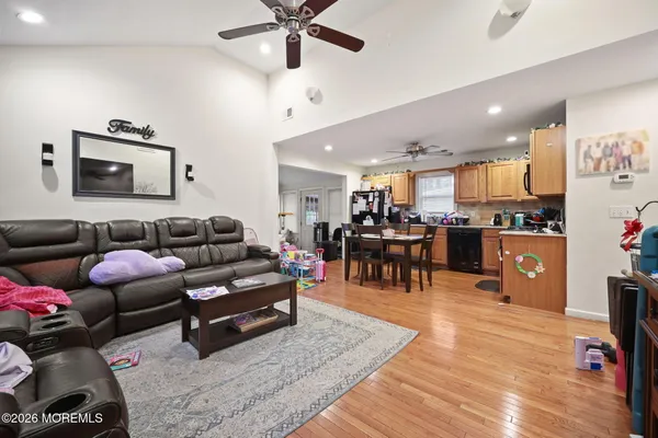 a living room with furniture and kitchen view
