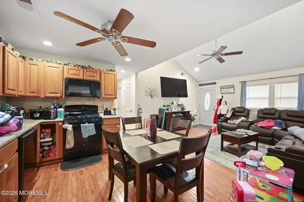 a view of a dining room with furniture and a kitchen