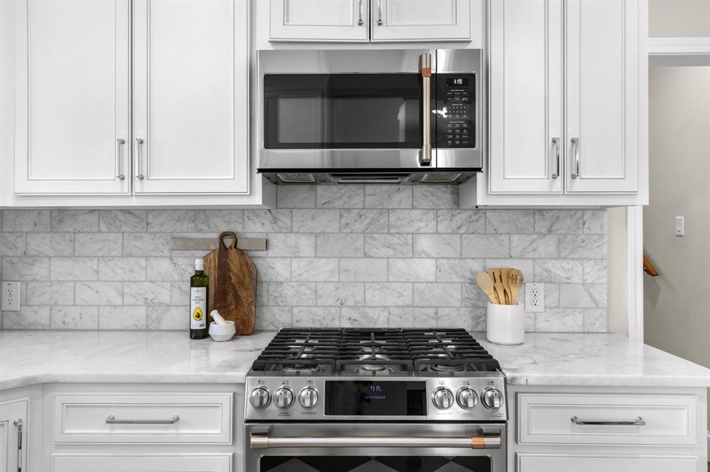 2815 Cumberland Avenue Waco, TX 76708 - Photo 14 of 40 a stove top oven sitting inside of a kitchen and white cabinets