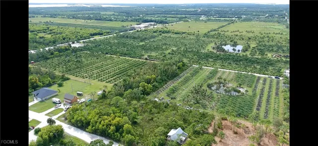 a view of a green field with an ocean view