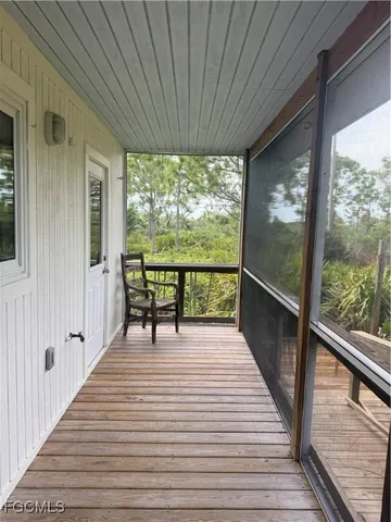 a view of balcony with wooden floor