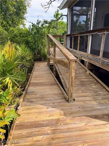 a view of balcony with wooden floor and fence