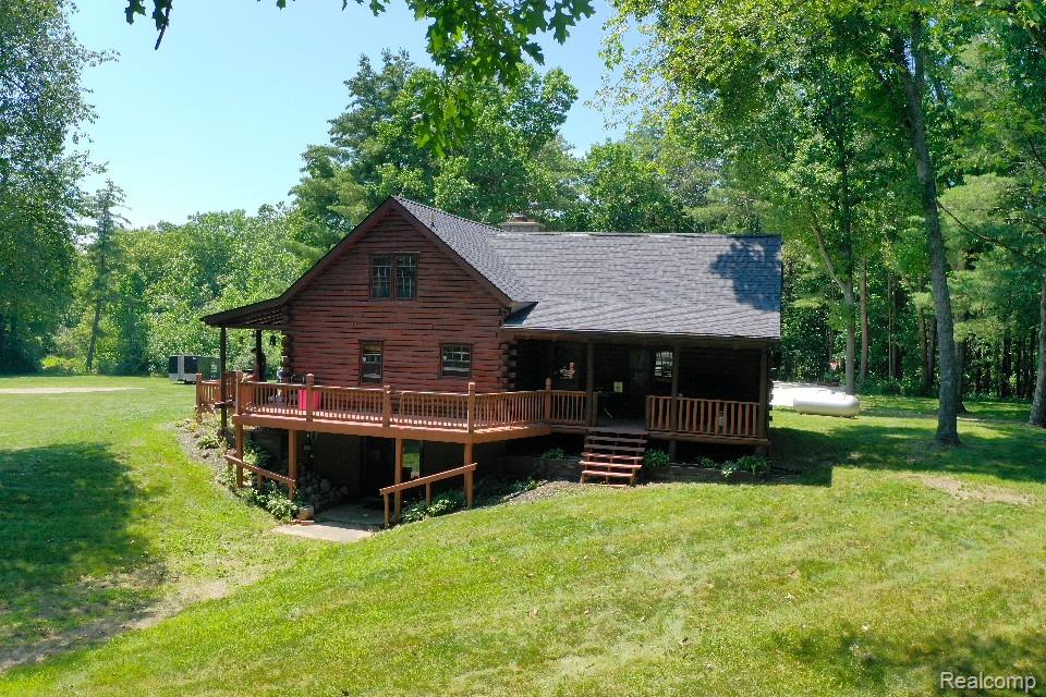 3656 Stanley Road Columbiaville, MI 48421 - Photo 57 of 65 Wood-sided home featuring a multi-level deck and covered porch