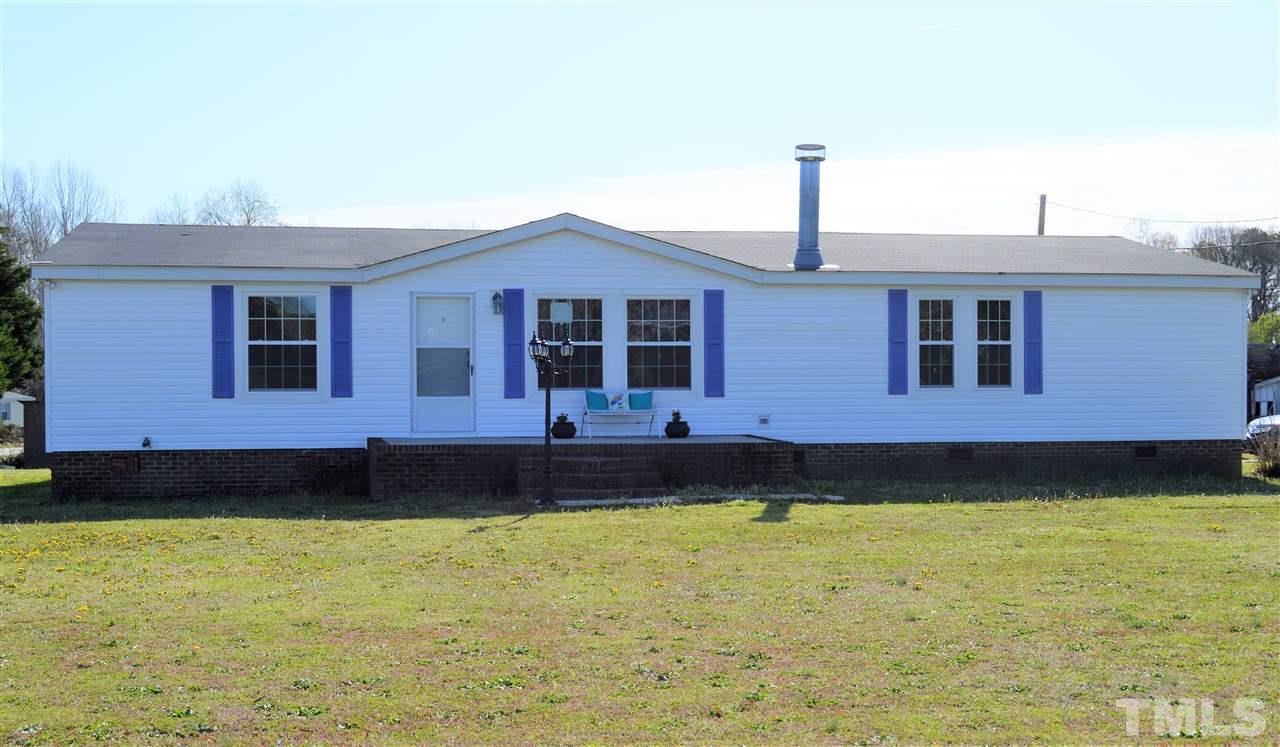 8701 Walter Myatt Road Willow Spring, NC 27592 - Photo 2 of 13 a front view of a house with a yard