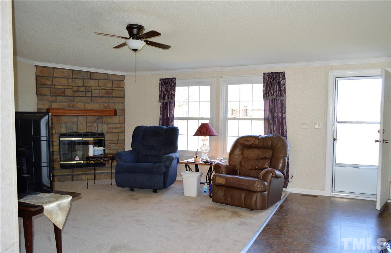 8701 Walter Myatt Road Willow Spring, NC 27592 - Photo 3 of 13 a living room with furniture and a window