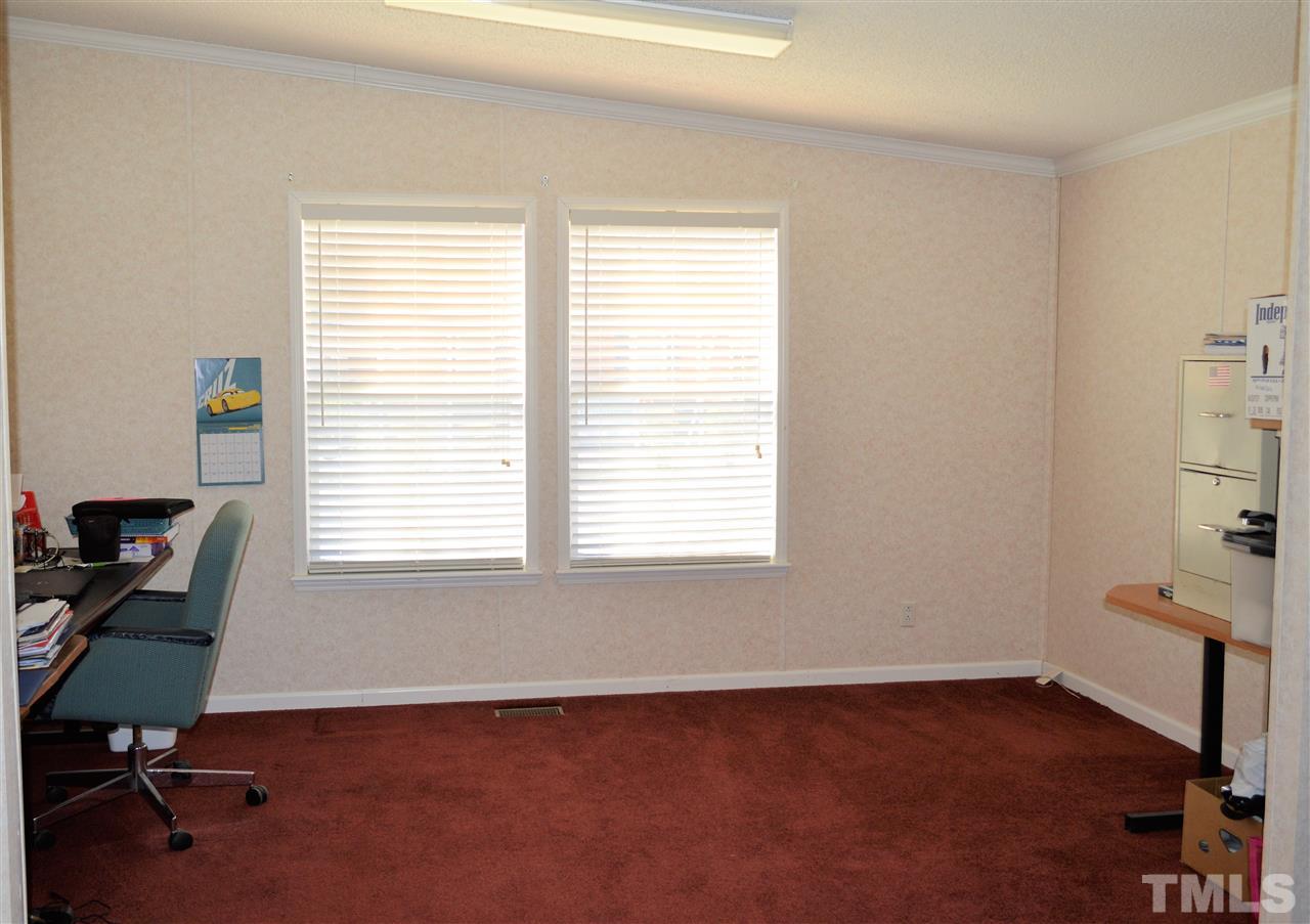 8701 Walter Myatt Road Willow Spring, NC 27592 - Photo 8 of 13 a view of a workspace with a window
