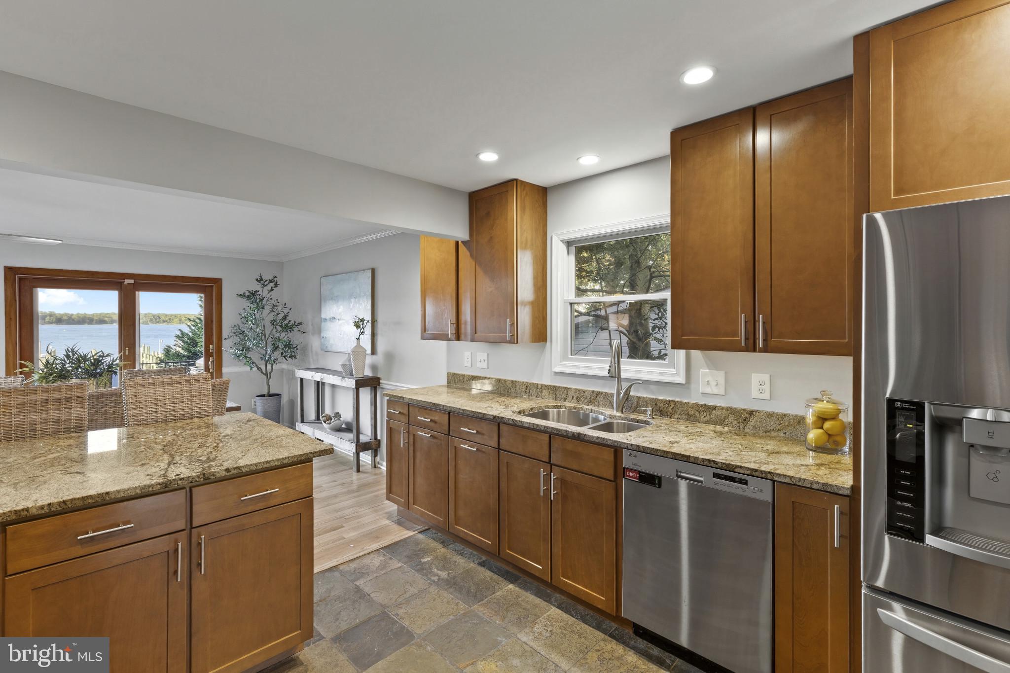 310 Magothy Road Severna Park, MD 21146 - Photo 10 of 38 a kitchen with stainless steel appliances granite countertop a sink stove and refrigerator