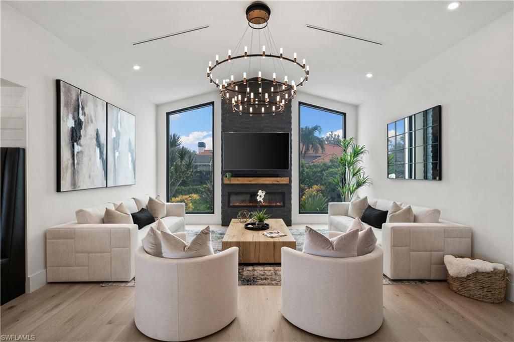 19559 Vintage Trace Circle Estero, FL 33967 - Photo 16 of 50 a living room with fireplace furniture and a large window