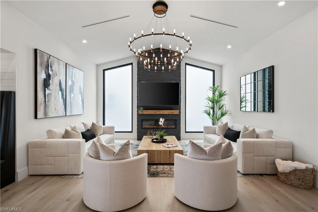 19559 Vintage Trace Circle Estero, FL 33967 - Photo 17 of 50 a living room with furniture and a large mirror