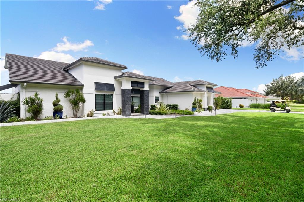 19559 Vintage Trace Circle Estero, FL 33967 - Photo 2 of 50 a front view of a house with a yard porch and outdoor seating