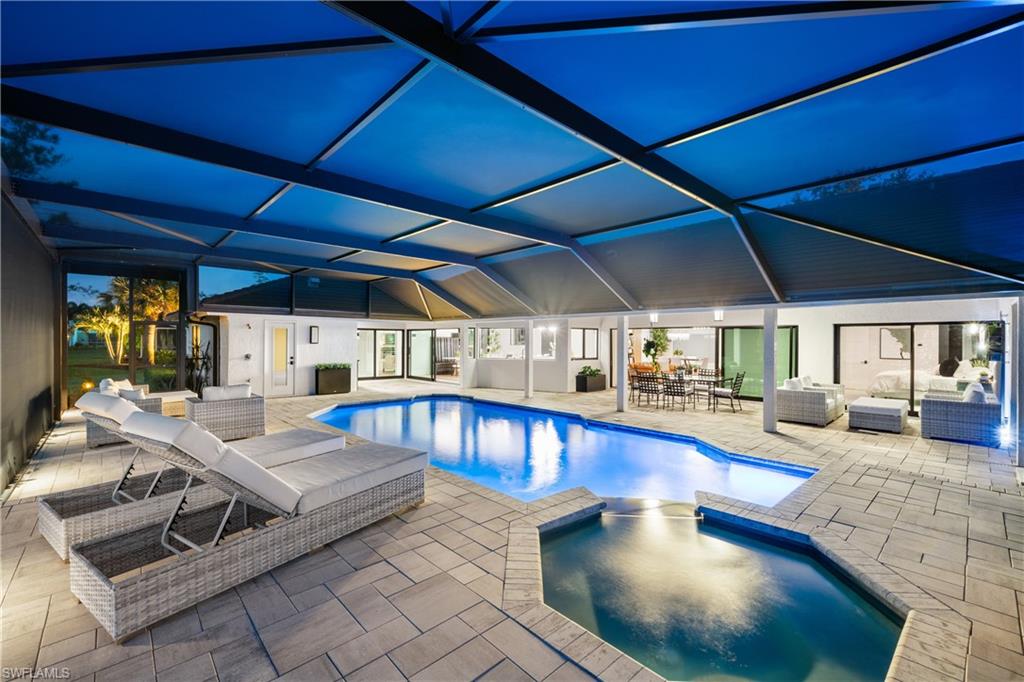 19559 Vintage Trace Circle Estero, FL 33967 - Photo 24 of 50 a living room with furniture and a chandelier