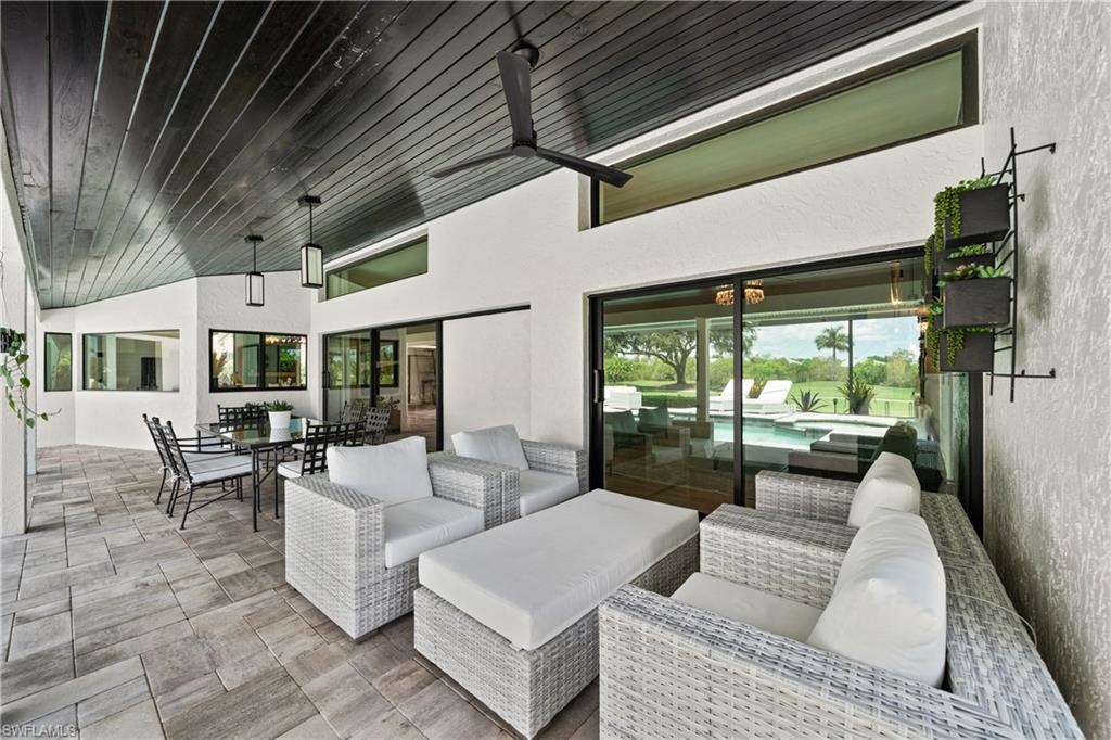 19559 Vintage Trace Circle Estero, FL 33967 - Photo 25 of 50 a living room with furniture and a large window
