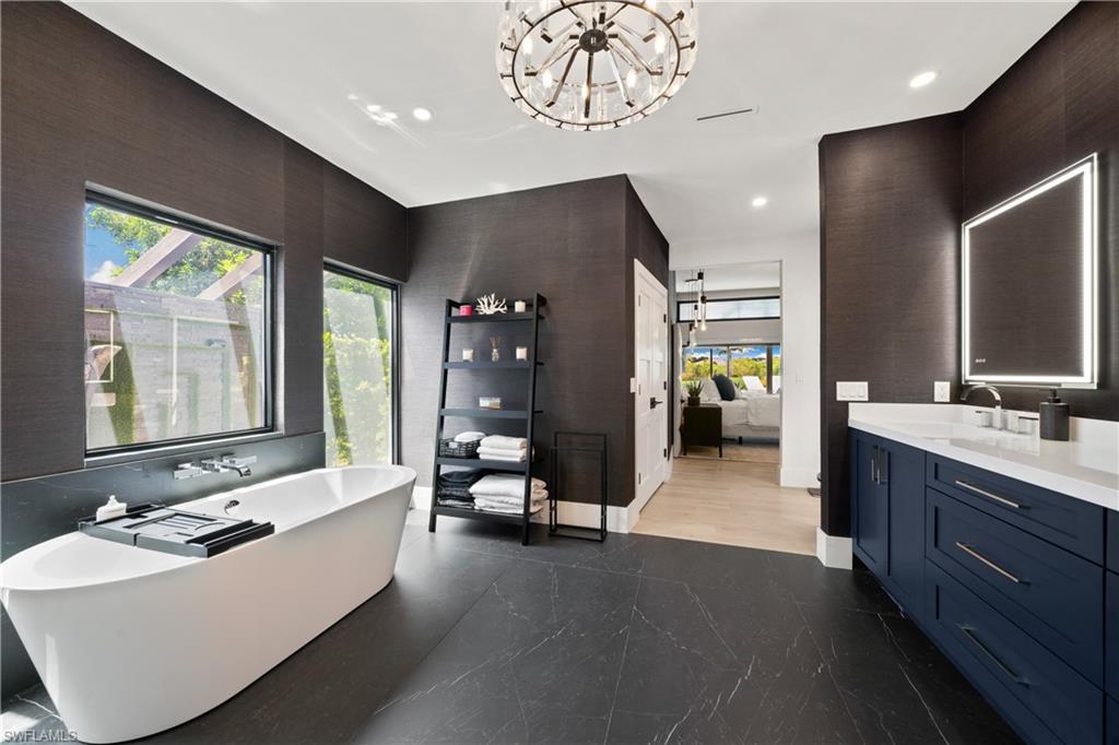 19559 Vintage Trace Circle Estero, FL 33967 - Photo 32 of 50 a large spacious bathroom with a large tub and sink