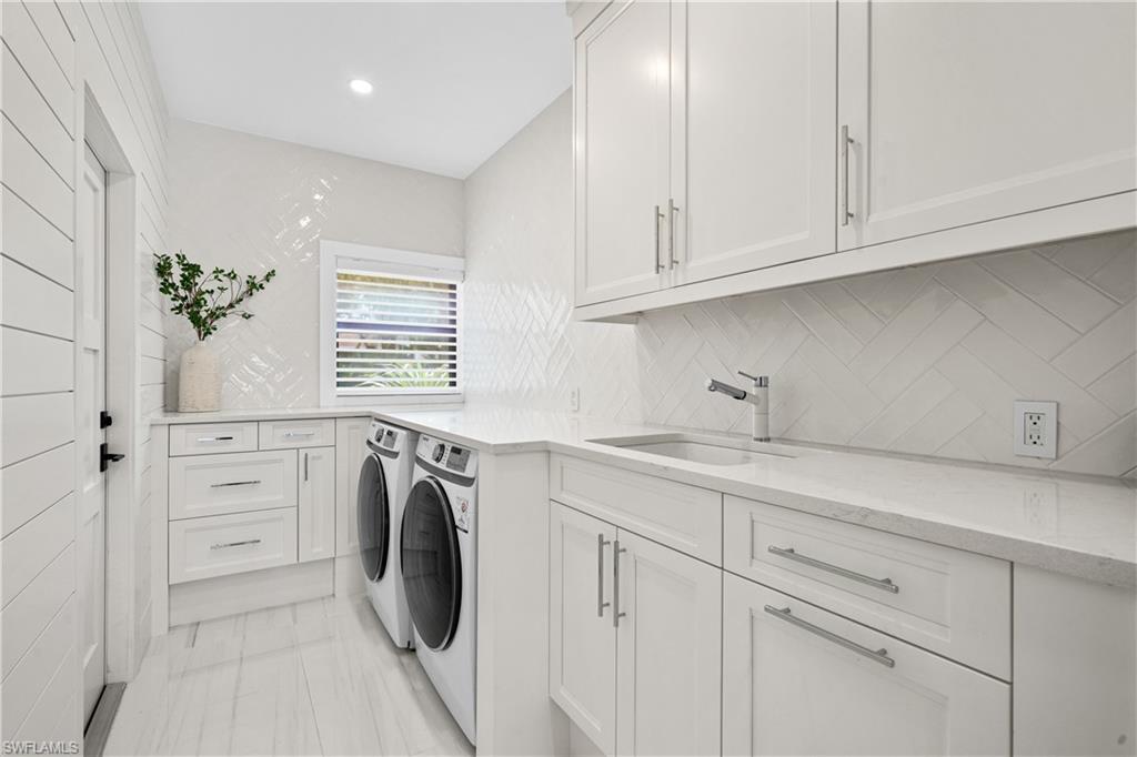 19559 Vintage Trace Circle Estero, FL 33967 - Photo 42 of 50 a utility room with stainless steel appliances white cabinets and a sink
