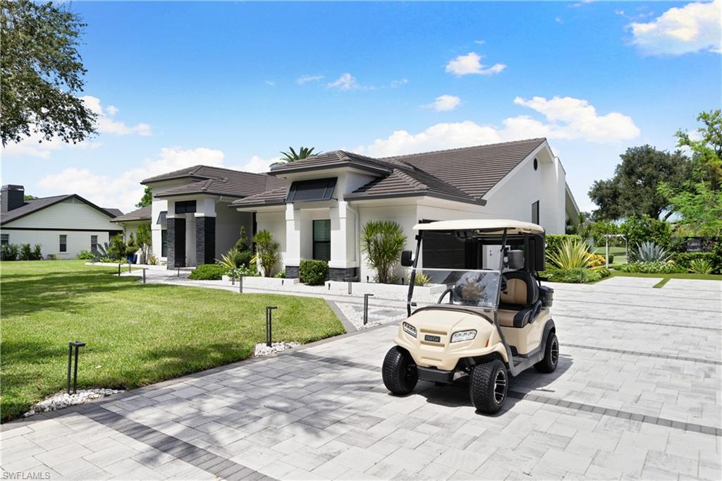 19559 Vintage Trace Circle Estero, FL 33967 - Photo 43 of 50 a front view of a house with garden