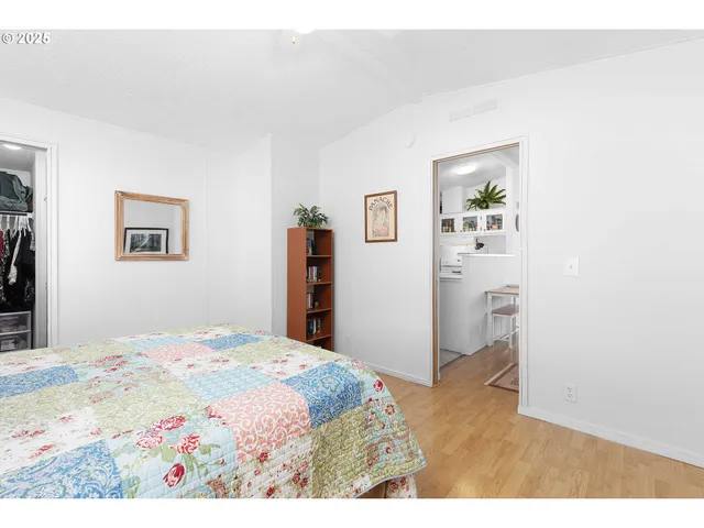 a bedroom with a bed and painting on the wall
