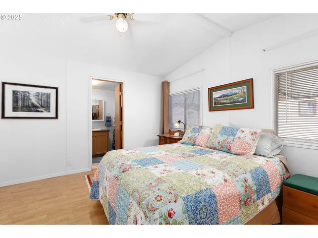 a bedroom with a bed and a painting on the wall