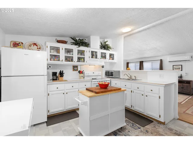 a kitchen with stainless steel appliances a sink and a refrigerator